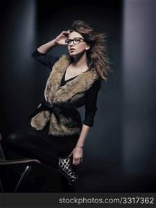 Fashion style photo of young brunette wearing glasses