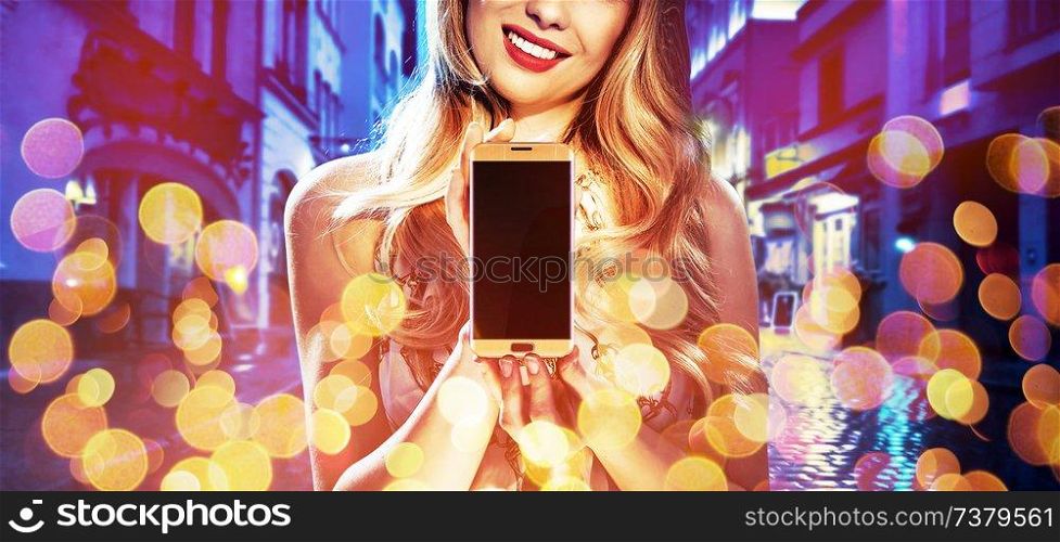 Fashion style portrait of a young woman holding an electronic device