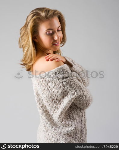 Fashion style portrait of young girl on grey background
