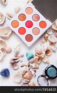 fashion summer coral eye palettes with  natural shells and gemstones around background. close up