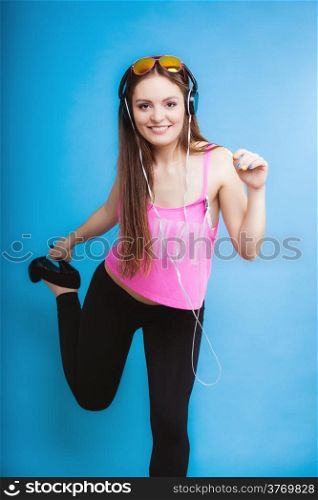 Fashion teen girl headphones listen music mp3 player, Fresh energetic young woman relax happy and dancing blue background