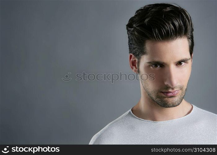 Fashion trendy young man silver futuristic portrait over gray