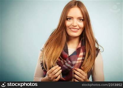 Fashion warm clothing concept. Beautiful model with winter clothes. Attractive woman wearing checkered scarf and thick sweather.. Beautiful model with winter clothes.