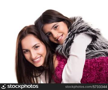 Fashion woman and girl posing over white background