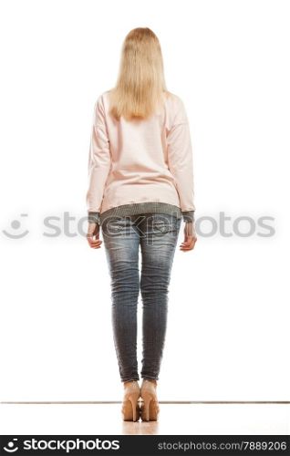 Fashion. Woman full length in denim trousers high heels shoes casual style back view isolated