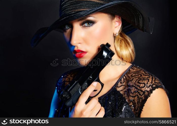 Fashion woman gangster style with handgun pistol on black background