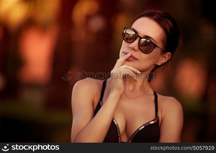 Fashion woman portrait, beautiful woman wearing stylish sunglasses and swimsuit, gorgeous female model outdoors, summer vacation look