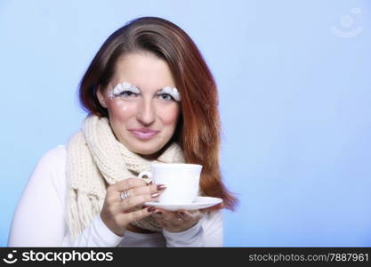 Fashion woman stylish winter makeup holding cup of hot drink beverge enjoying coffee time copyspace blue background