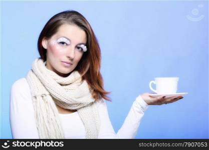 Fashion woman stylish winter makeup holding cup of hot drink beverge enjoying coffee time copyspace blue background