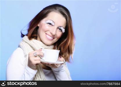 Fashion woman stylish winter makeup holding cup of latte coffee hot drink time for enjoyment copyspace blue background