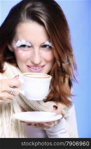 Fashion woman stylish winter makeup holding cup of latte coffee hot drink time for enjoyment blue background
