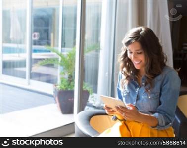 Fashion woman using tablet with sunbeams and lens flare