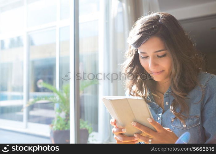 Fashion woman using tablet with sunbeams and lens flare