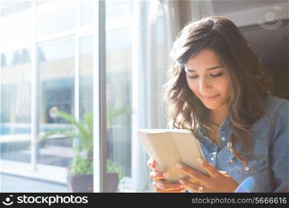 Fashion woman using tablet with sunbeams and lens flare