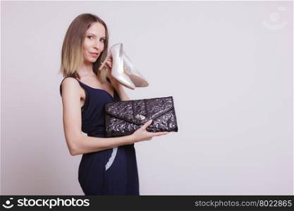 Fashion woman with leather handbag and high heels.. Elegant woman with leather handbag and high heels. Stylish girl holding black bag and shoes. Fashion. Studio.