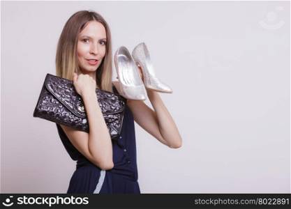 Fashion woman with leather handbag and high heels.. Elegant fashionable woman with leather handbag and high heels. Stylish girl on gray holding black bag and silver shoes. Female fashion vogue. Studio.
