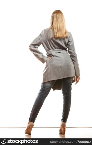 Fashion. Young blonde fashionable woman in elegant gray belt coat. Female model in full body rear view isolated on white