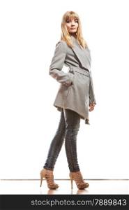Fashion. Young blonde fashionable woman in elegant gray belt coat. Female model posing isolated on white background