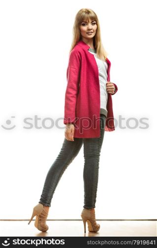 Fashion. Young blonde fashionable woman in full body wearing vivid color red pink wool coat high heels shoes. Female model posing isolated on white