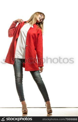 Fashion. Young blonde fashionable woman in full body wearing vivid color red wool coat high heels shoes. Female model posing isolated on white