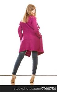 Fashion. Young blonde fashionable woman in vivid color pink coat. Female model rear view isolated on white background