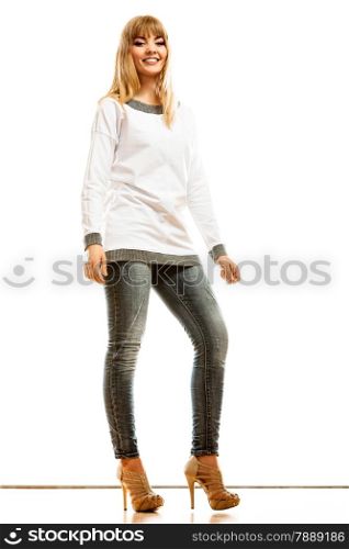 Fashion. Young blonde fashionable woman jeans pants white long-sleeved shirt. Female model posing isolated studio shot