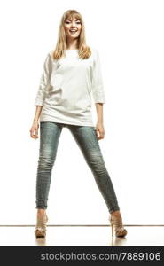 Fashion. Young blonde woman denim pants white bat sleeve top high heels. Female model posing in full length isolated