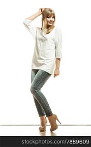 Fashion. Young blonde woman denim pants white bat sleeve top high heels. Female model posing in full length isolated