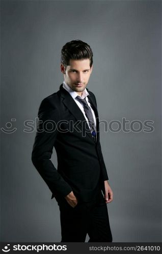 Fashion young businessman black suit casual tie on gray background