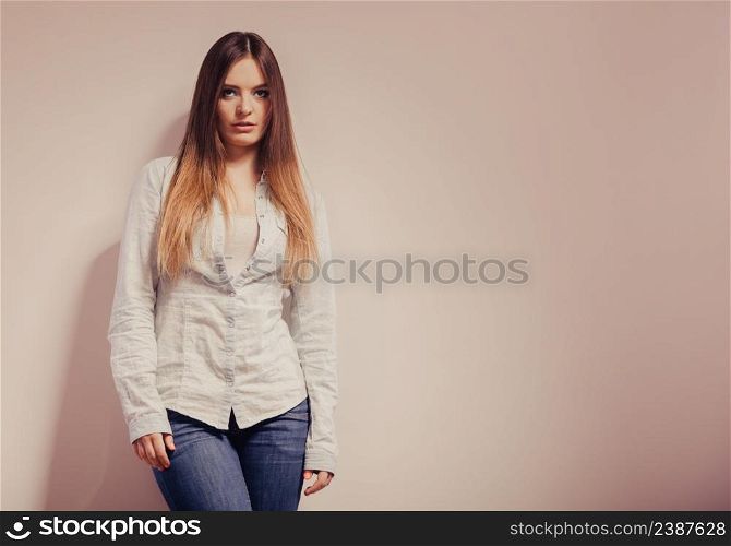 Fashion. Young long hair fashionable woman jeans pants shirt. Female model posing text area filtered photo