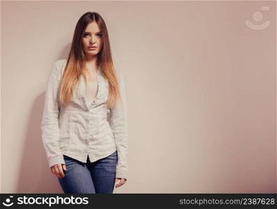 Fashion. Young long hair fashionable woman jeans pants shirt. Female model posing text area filtered photo