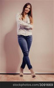 Fashion. Young long hair fashionable woman jeans pants shirt. Female model posing in full body filtered photo