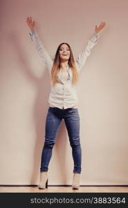 Fashion. Young long hair fashionable woman jeans pants shirt. Female model posing in full body filtered photo