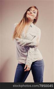 Fashion. Young long hair fashionable woman jeans pants shirt. Female model posing filtered photo