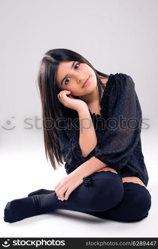 Fashion young model posing over grey background