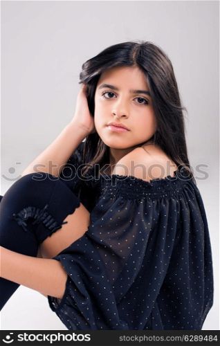 Fashion young model posing over grey background