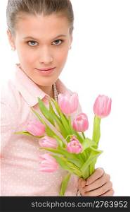 Fashion - young romantic woman in designer clothes with spring tulips