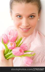 Fashion - young romantic woman in designer clothes with spring tulips