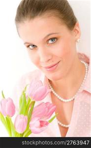 Fashion - young romantic woman with spring tulips in designer clothes