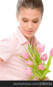 Fashion - young romantic woman with spring tulips in designer clothes
