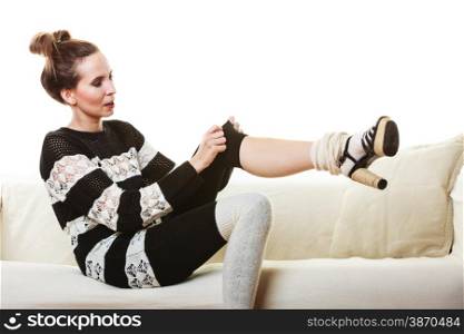 Fashion young woman. Girl in fashionable striped white black dress posing on white couch.