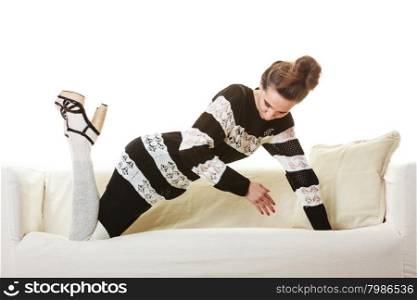 Fashion young woman in full length. Girl in fashionable striped dress high heels posing on white couch.