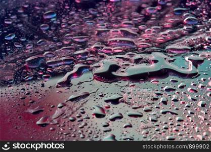 Fashionable background with UV effect lighting close-up water droplets. Trendy backdrop for your design.. Abstract close-up water background with neon lights.