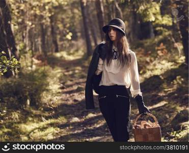 Fashionable beautiful woman and mushroom basket - warm tinted image