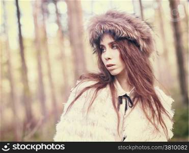 Fashionable beautiful woman in the forest - warm tinted image