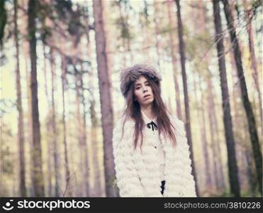 Fashionable beautiful woman in the forest - warm tinted image