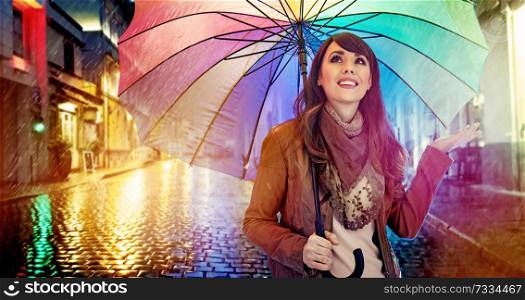 Fashionable brunette lady with a colorful umbrella