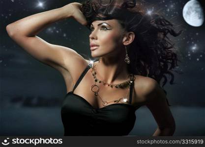 Fashionable brunette over starry night background
