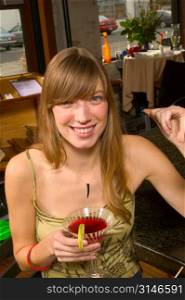 Fashionable Caucasian Girl Drinking A Cocktail In A Trendy Corner Bar