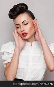 fashionable emotive model. Updo, vintage accessories. Makeup and hairstyle. Red lips, large earrings